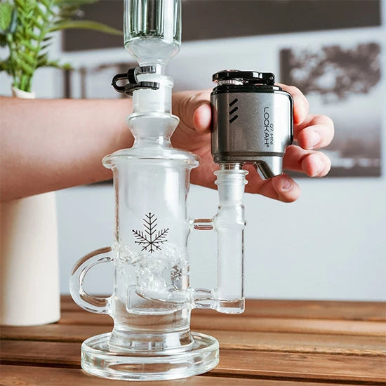 a close up of the Freeze Pipe Q7 Mini E-nail with a Freeze Pipe Recycler bong
