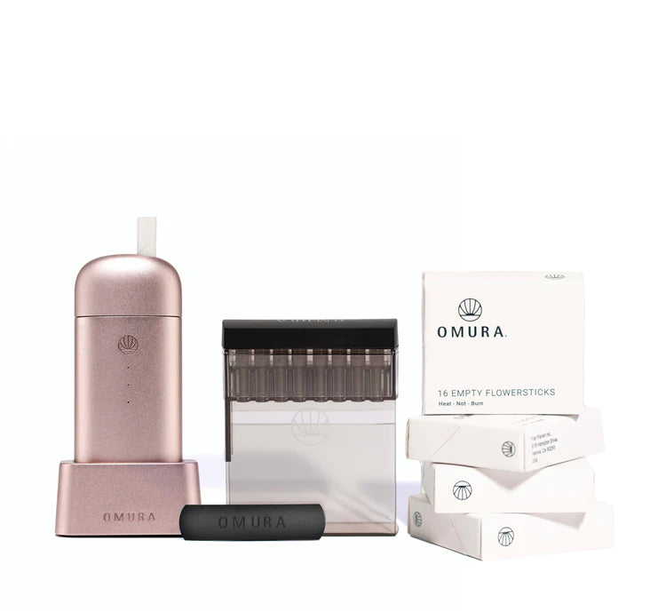 Elegant Omura X1 Starter Bundle in Rose Gold, featuring the Series X vaporizer with its sleek design, Home Fill System, and Flowerstick packs. The image showcases the vaporizer's luxurious Rose Gold finish and its accompanying modern charging base, highlighting the device's advanced technology and eco-friendly attributes